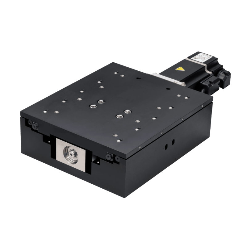 A black motorized linear stage with multiple screw holes on its platform, a motor attached on one side, and a metal component on the front, used for precise positioning in automation or research.