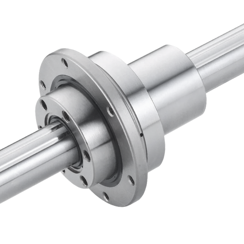 A close-up of a linear bearing on a steel shaft, showing a cylindrical metal component with mounting holes and polished surfaces, used for smooth linear motion in machinery.