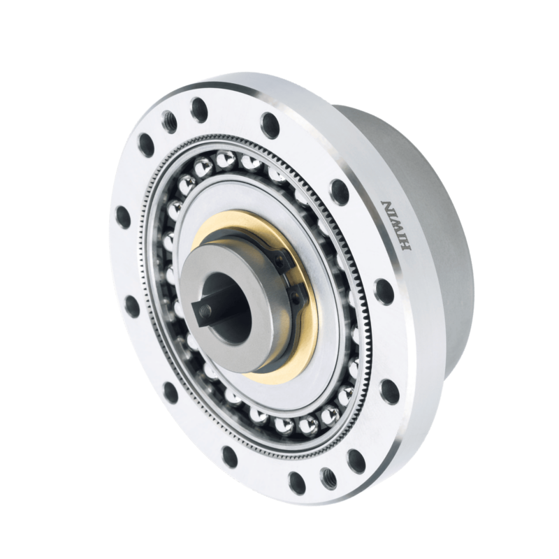A close-up of a precision mechanical gear component with ball bearings, metal plates, and the brand name Harmonic Drive engraved on the side, isolated on a light background.