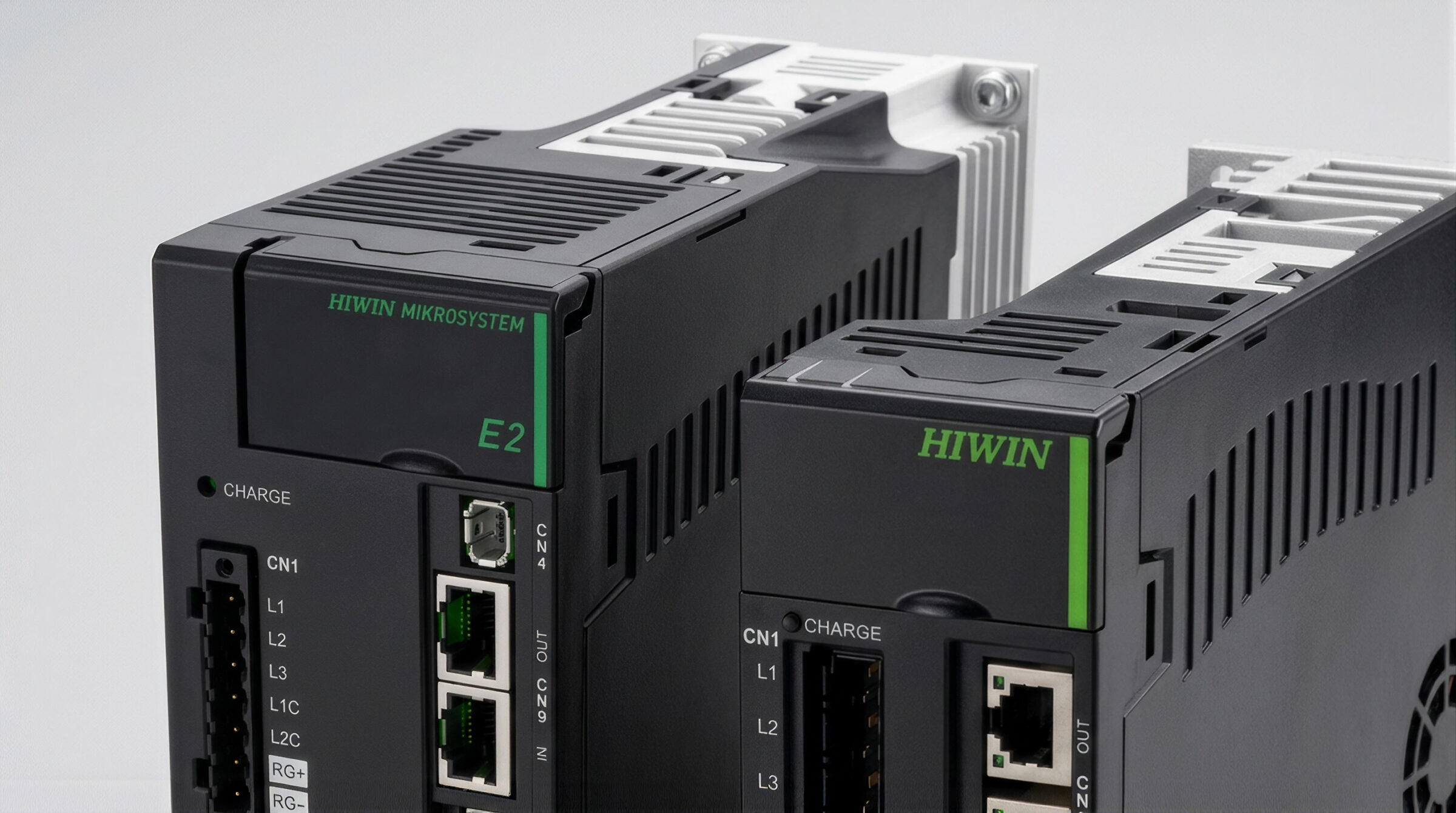 Close-up of two black HIWIN electronic devices with green labels, network ports, and connectors, positioned side by side against a plain background.
