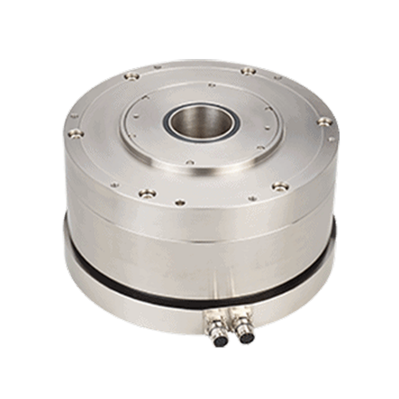 A metal cylindrical device with a central hole, multiple bolt holes on the top surface, and two cable connectors at the bottom front. The background is white.